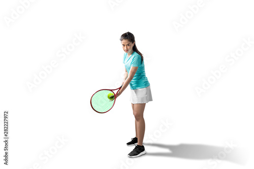 Asian woman with a tennis racket and ball in her hands ready in serve position © Leo Lintang