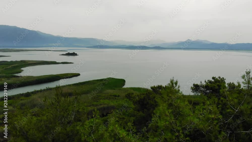 A scenic aerial view of Lake Koycegiz (Mediterranean coast, Turkey); taken with a drone on a hazy summer morning. A scenic aerial view of Lake Koycegiz (Mediterranean coast, Turkey); taken with a drone on a hazy summer morning.