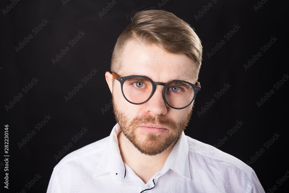 Portrait, guy and business people concept - Handsome man with glasses in white shirt looking at camera Portrait, guy and business people concept - Handsome man with glasses in white shirt looking at camera