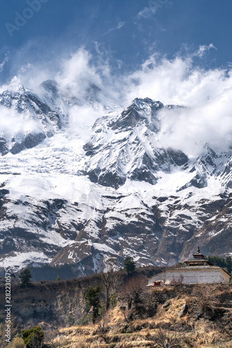 The view on Dhaulagiri peak and buddhist monastery photo