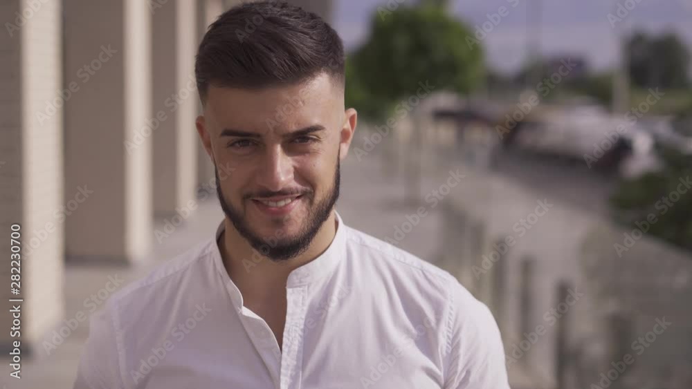 Businessman with black beard. Serious man. young successful businessman looks at camera and smile. 4k video Businessman with black beard. Serious man. young successful businessman looks at camera and smile. 4k video