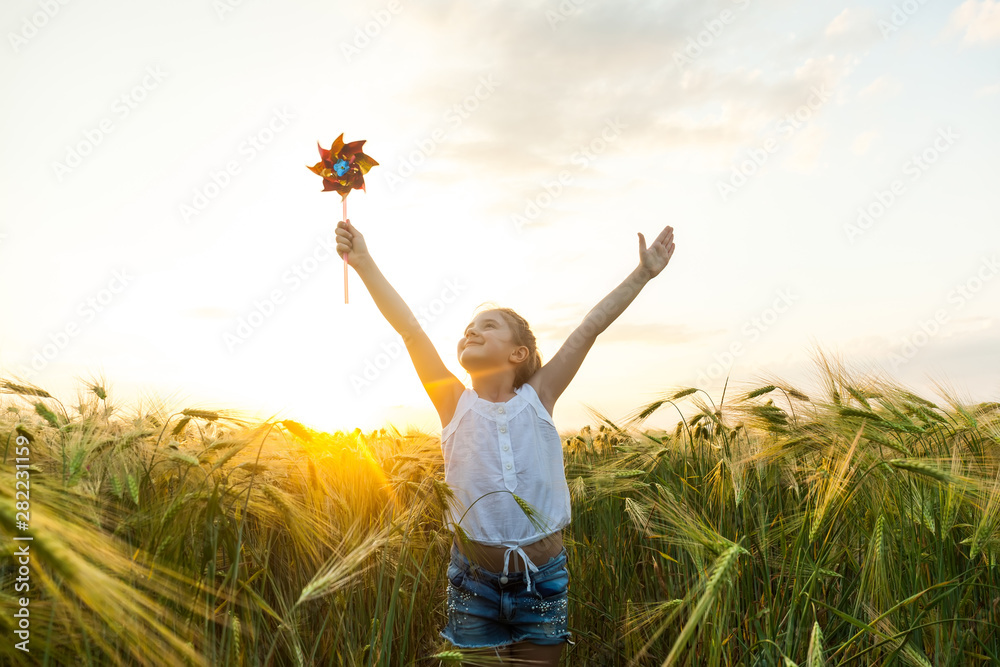 Little girl playing on the meadow in wheat field. Little girl playing on the meadow in wheat field.
