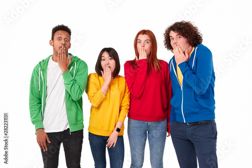 Shocked multiethnic students covering mouths