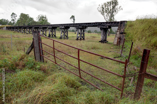rail bridge with a rusty gate in the forground © Brian