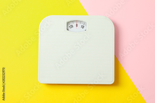 Fotografi White weigh scales on two tone background, space for text