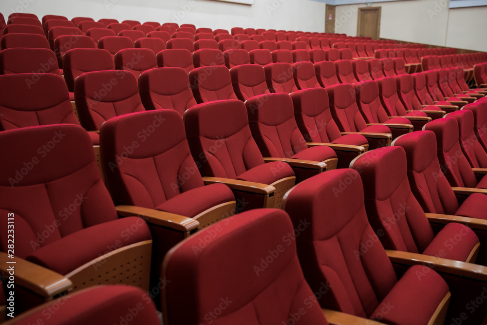 Fototapeta premium Close-up shot of red chair seats in empty conference room