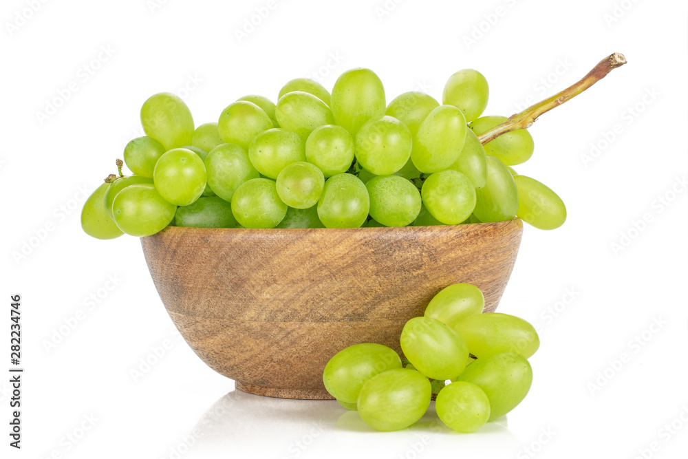 Lot of whole fresh green grape small bunch is aside in big wooden bowl isolated on white background Lot of whole fresh green grape small bunch is aside in big wooden bowl isolated on white background