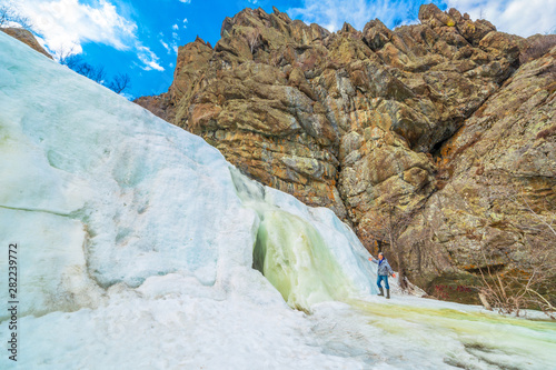 Beautiful frozen gadelsha waterfall in the southern Urals in the Republic of Bashkortostan on a spring sunny day. photo