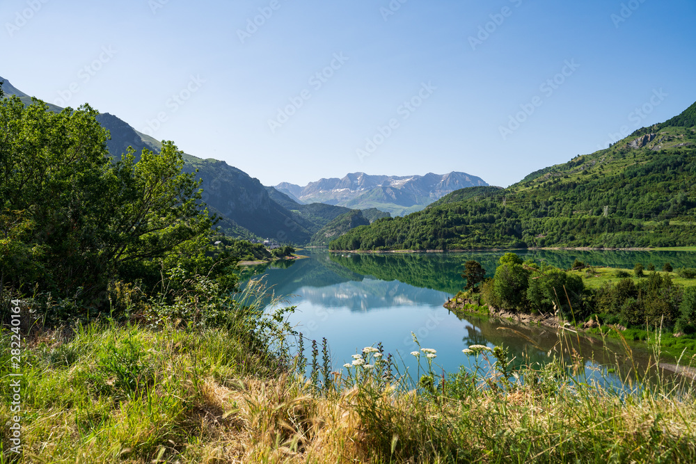 Lanuza reservoir. Landscape of a reservoir surrounded by mountains on a sunny day.