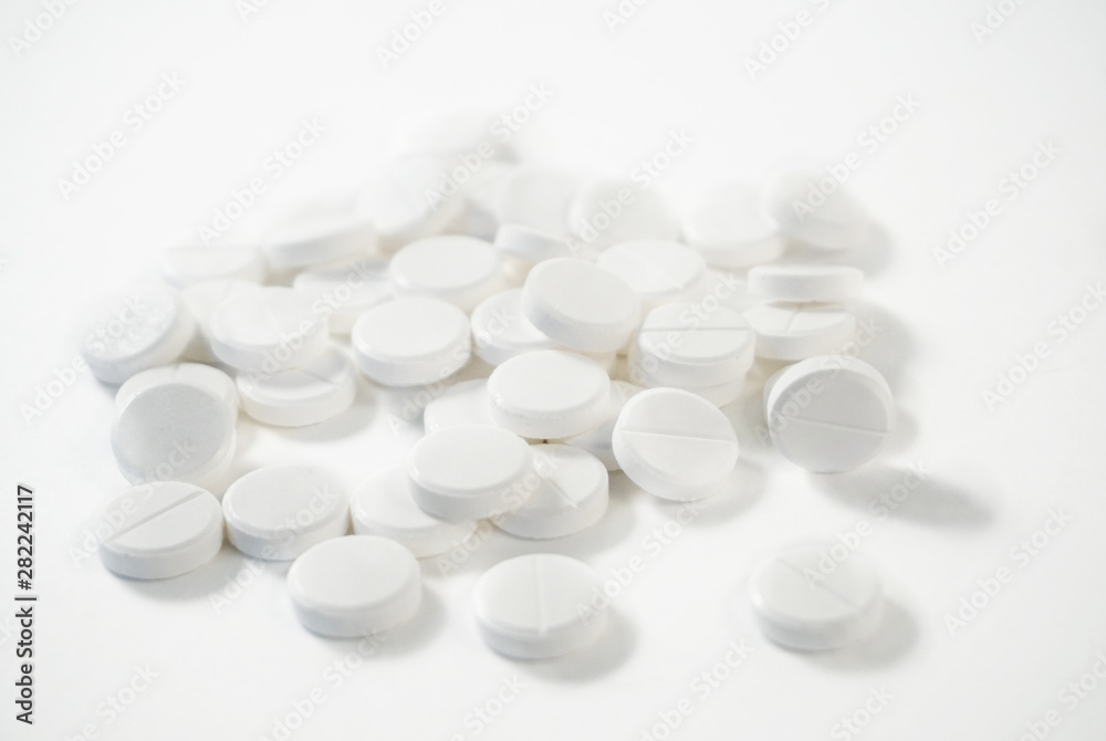 white pills on a white background