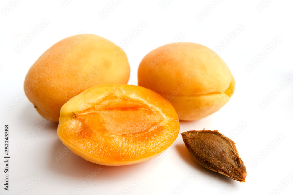 Isolated apricots. Fresh whole apricot fruit with leaf and half isolated on white background with clipping path Isolated apricots. Fresh whole apricot fruit with leaf and half isolated on white background with clipping path