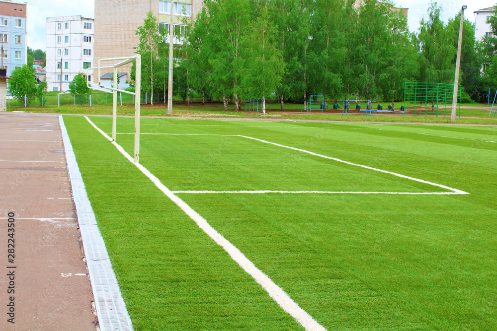 New artificial football field. School stadium. Background.