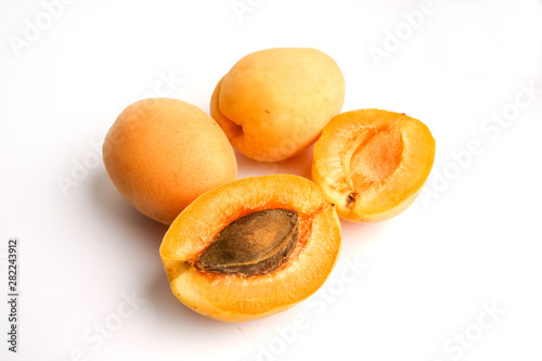 Isolated apricots. Fresh whole apricot fruit with leaf and half isolated on white background with clipping path