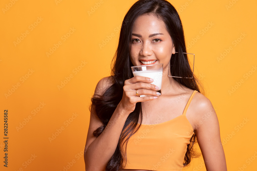 Healthy Asian woman drinking a glass of milk. Healthy Asian woman drinking a glass of milk.