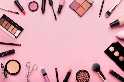 Frame of professional cosmetics and brushes around blank space