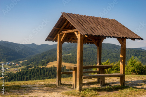 covered gazebo with table and benches overlooking the mountains © Mike Mareen