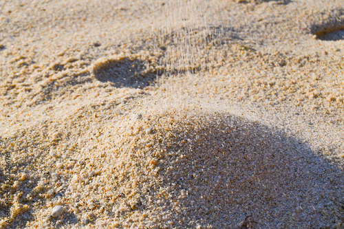 Sand falling on a beach