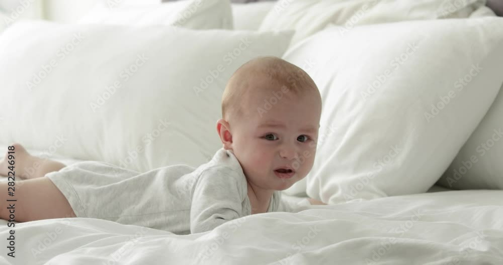 Upset little child crying on bed at home Upset little child crying on bed at home