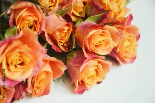 bouquet of beautiful pink and orange roses on a light background. bouquet of flowers.