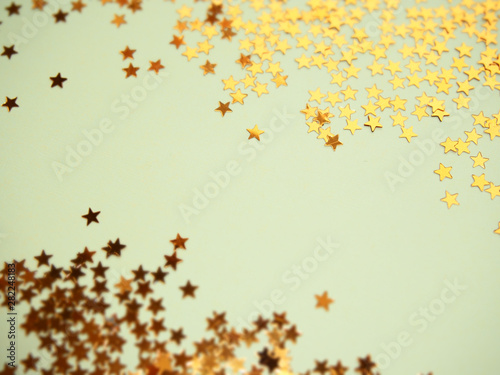 Golden stars glitter on blue background