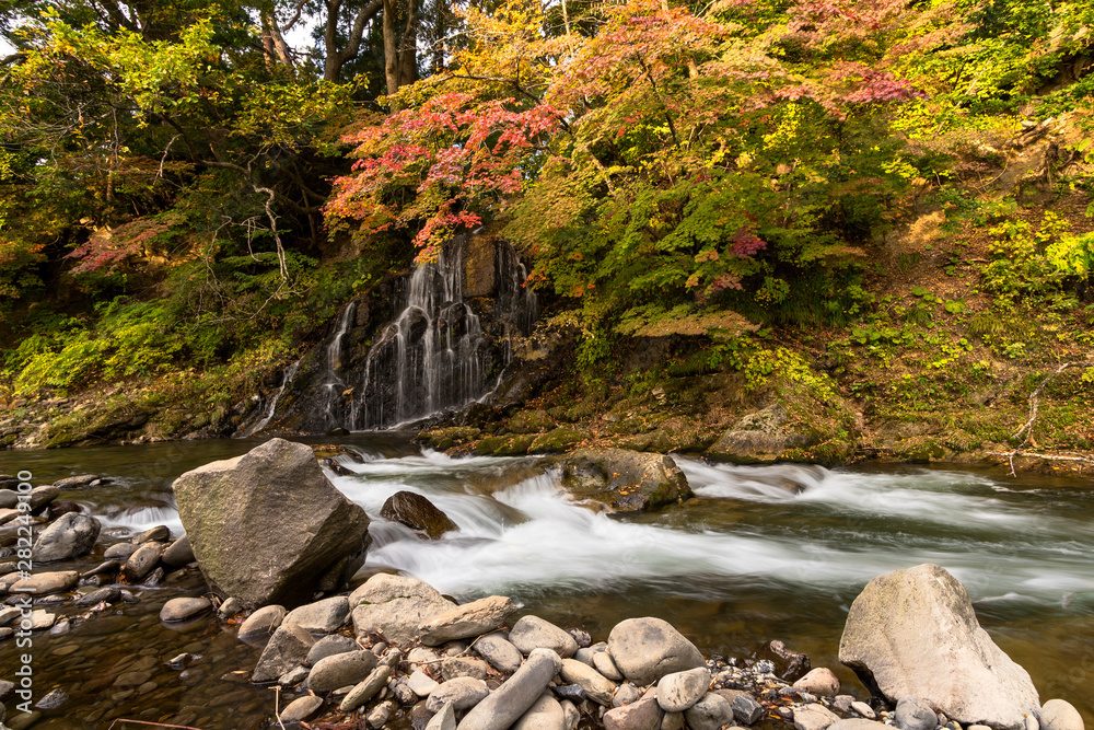 Autumn leaves and waterfall at Nakano Momiji mountain, Kuroishi, Aomori, Japan Autumn leaves and waterfall at Nakano Momiji mountain, Kuroishi, Aomori, Japan