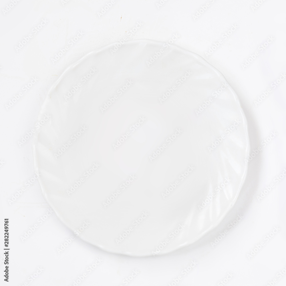 White plate on white background top view. Flat lay. White plate on white background top view. Flat lay.