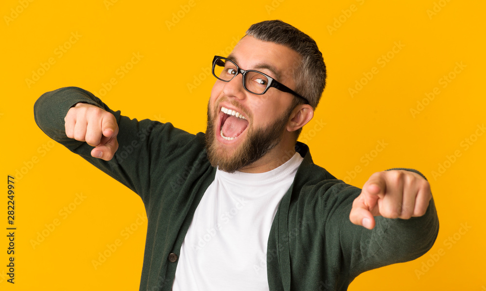 Fototapeta premium Cheerful bearded man happily indicating at camera