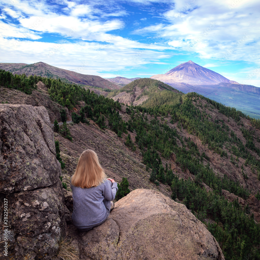 Naklejka premium Girl enjoying the view of volcano Teide in Teide National Park of Tenerife.