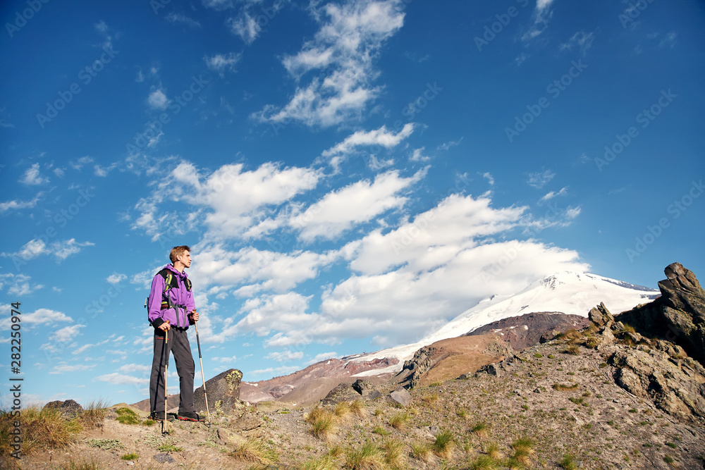 climber on trail in the mountains. man with a backpack in a hike climber on trail in the mountains. man with a backpack in a hike
