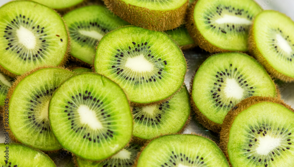 Kiwi fruits sliced in circles lie on the table. Kiwi fruits sliced in circles lie on the table.