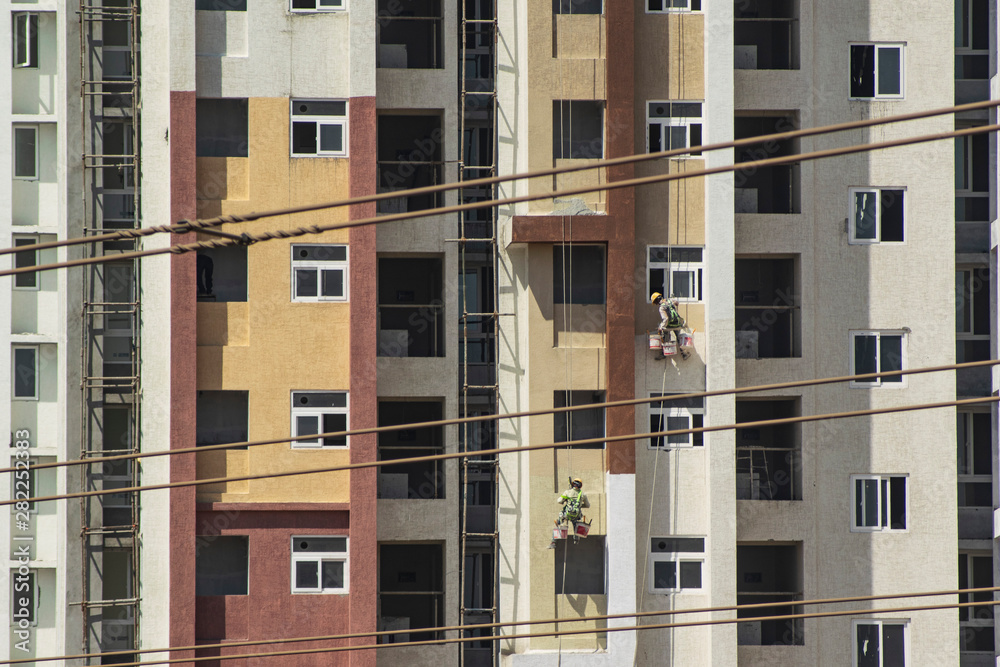 Fototapeta premium Workers painting the newly built apartment