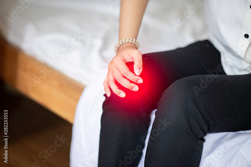 woman have a kneecap pain sitting on sofa feeling so illness,Healthcare concept