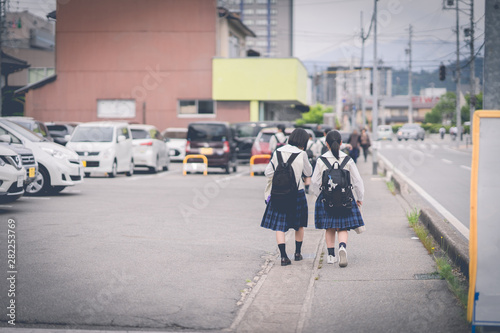 Japanese students are walking home with friends.
