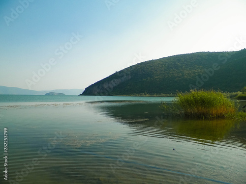 Coast of Lake Prespa and Mountains of Galicica National Park.