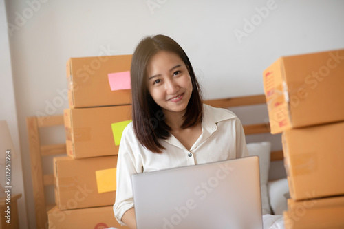 SME entrepreneur of Young Asian women working with laptop for Online shopping at home,Cheerful and Happy with box for packaging in home,Own Business Start up for Business Online and Online shopping © 220 Selfmade studio
