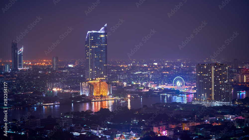night cityscape along chao praya river of bangkok