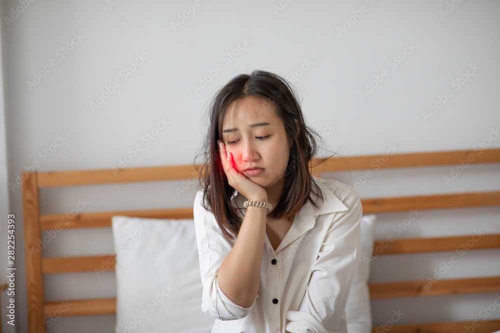 young Asian woman have a toothache feeling so painful,Healthcare Concept