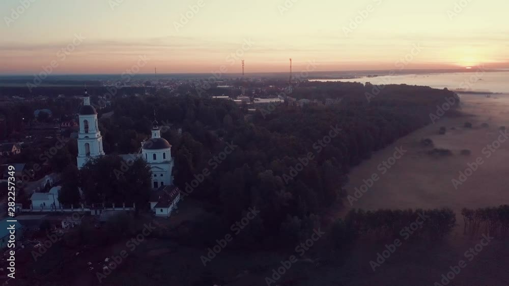 View from air on the orthodox Christian monastery in the dawn foggy morning. Russian province View from air on the orthodox Christian monastery in the dawn foggy morning. Russian province