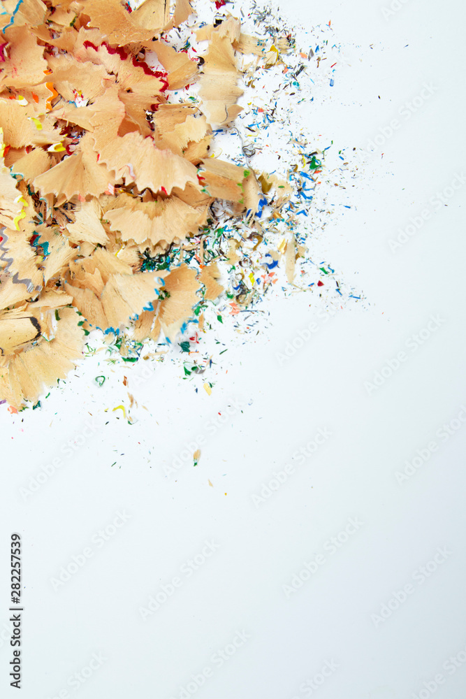 Naklejka premium Shavings from multicolored pencils on white