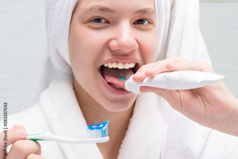 girl eating toothpaste from a tube in the bathroom Stock Photo Adobe