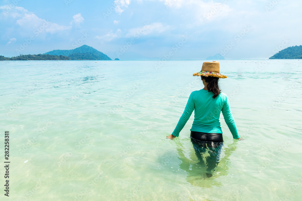 Young beautiful woman in swimsuit play in the sea water of andaman sea at summer sunny day Young beautiful woman in swimsuit play in the sea water of andaman sea at summer sunny day
