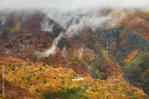 View of vibrant autumn colors (foliage) at Chuzenji lake Mt. Nantai waterfall and 1st Irohazaka, Nikko, Kanto Prefecture, Japan