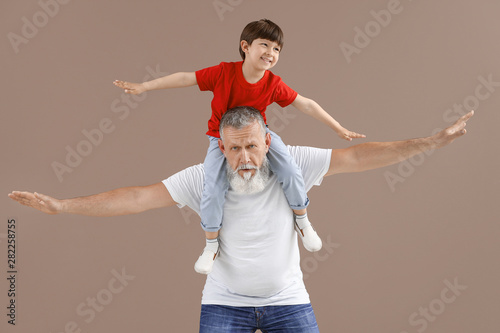 Funny little boy with grand...