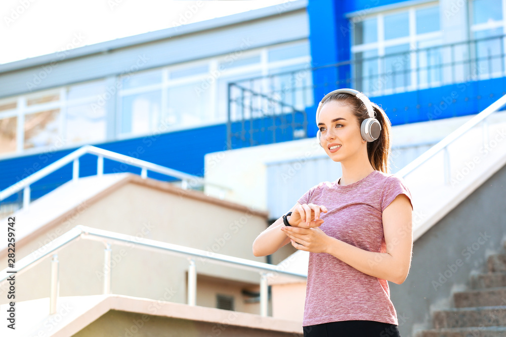 Sporty young woman checking her pulse outdoors Sporty young woman checking her pulse outdoors