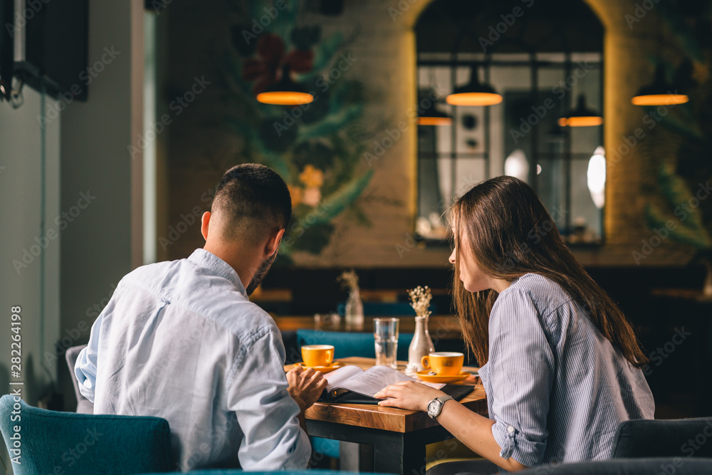 A happy young couple on a date at a fancy restaurant