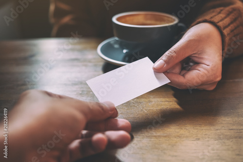 Two businessman holding and exchanging empty business card