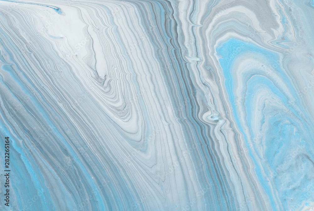 photography of abstract marbleized effect background. Blue, gray and white creative colors. Beautiful paint