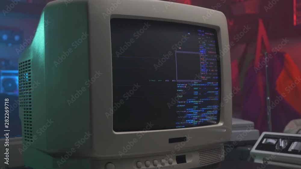 hacking screen with coding on a retro old computer monitor or TV from the 90s 80s