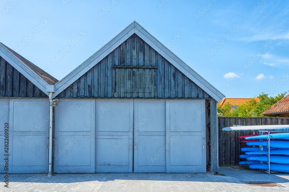 Obraz premium Beautiful wooden garage door for boats. Architecture. Details