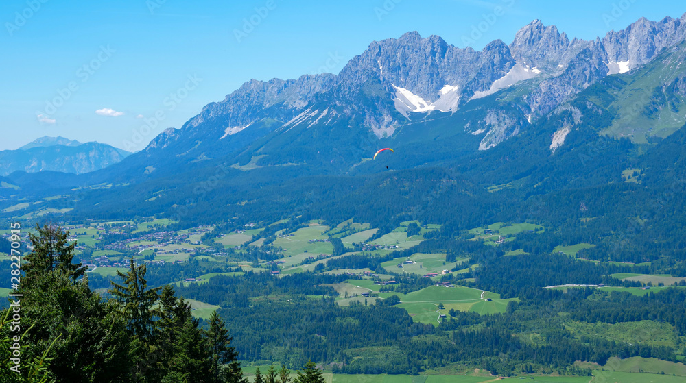 Beautiful alpine landscape with green meadows, alpine cottages and mountain peaks, Tyrol Alps, Austria